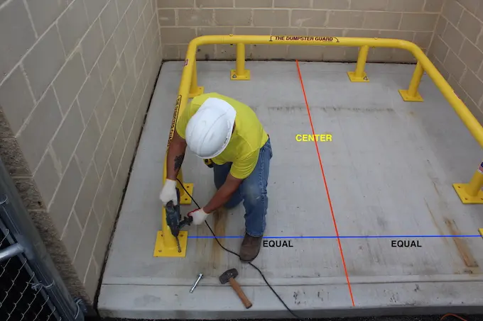 overhead drill in cement man in white helmet