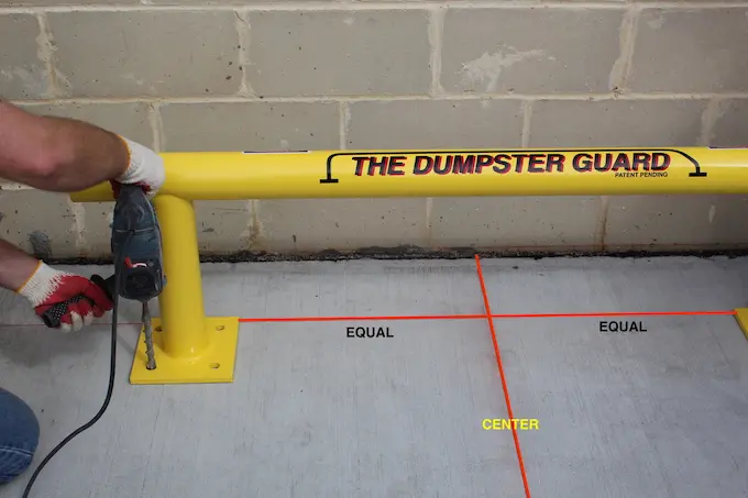 screwing down the dumpster guard in cememt